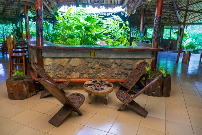 The lounge area, open to greenery on every side